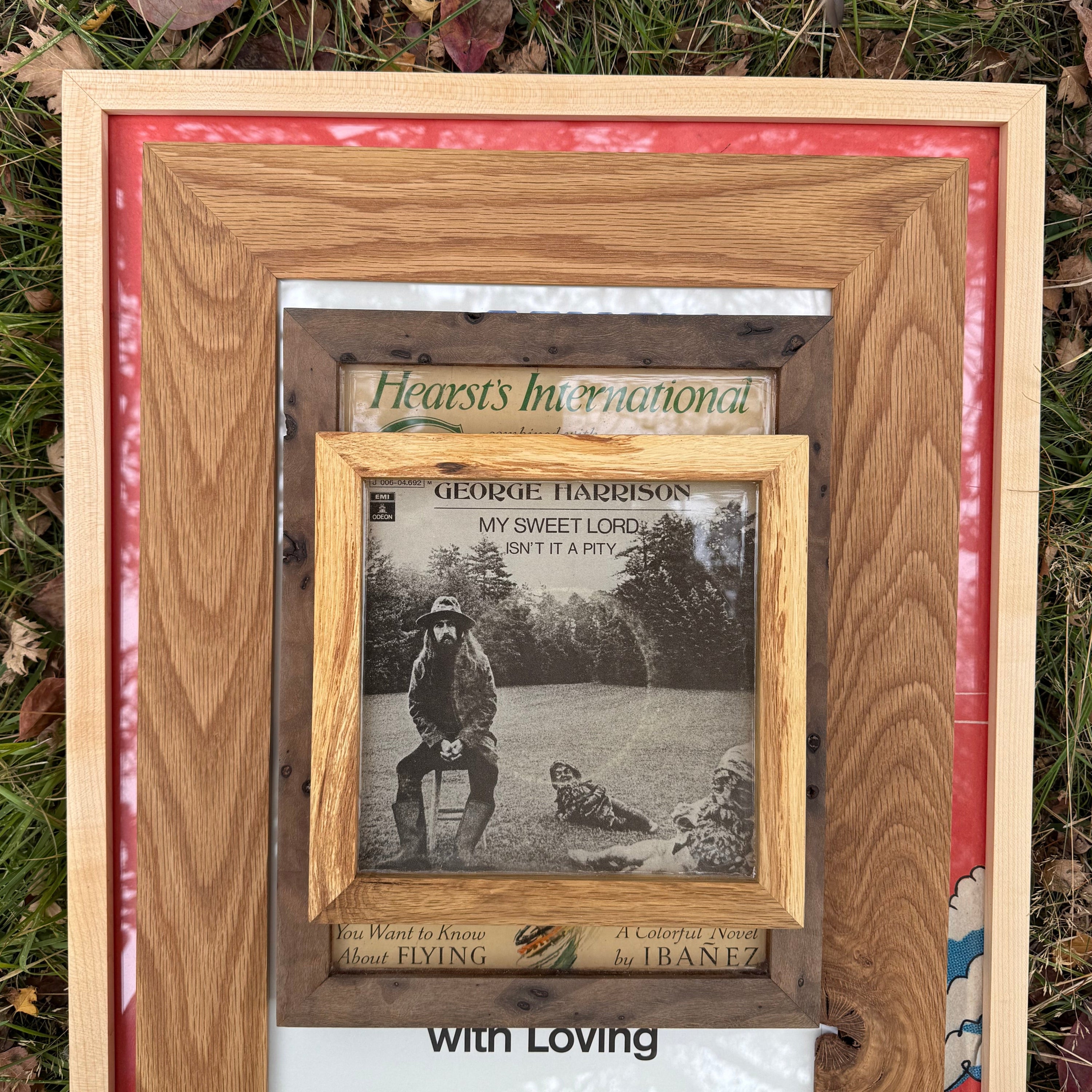 Wooden picture frame with a smaller inset frame containing a black and white photo of a person with a dog.