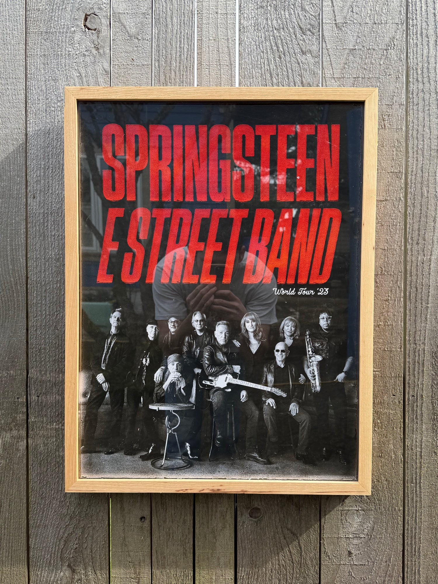 Framed poster of Springsteen E Street Band with red text on a wooden background